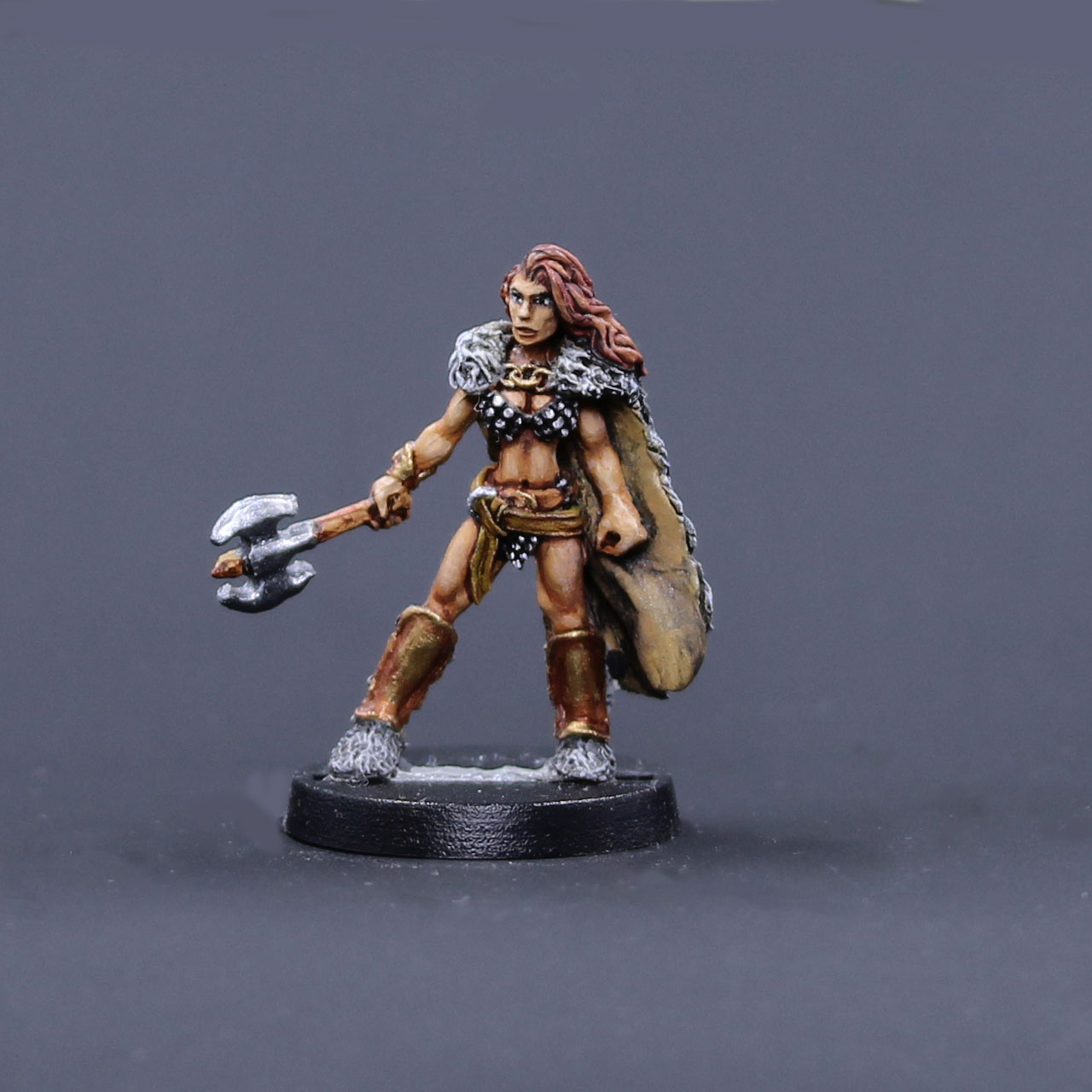 Northern barbarian female in wolf pelt cape with axe