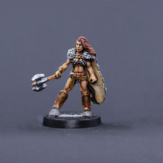 Northern barbarian female in wolf pelt cape with axe